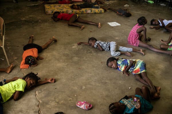 Children slept on the floor of a makeshift shelter after fleeing gang violence. Credit: Odelyn Joseph/Associated Press