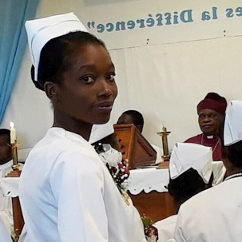A young nurse in a traditional white uniform and cap looks over her shoulder during a ceremony inside a church.